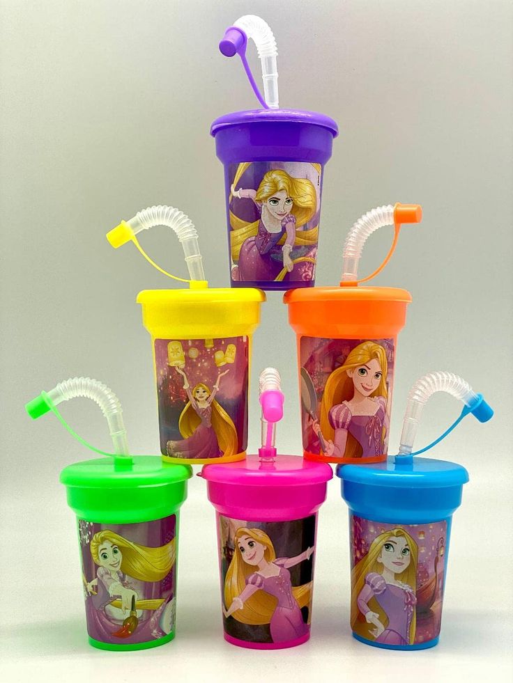 the cups are all different colors and have toothbrushes in each one's mouth