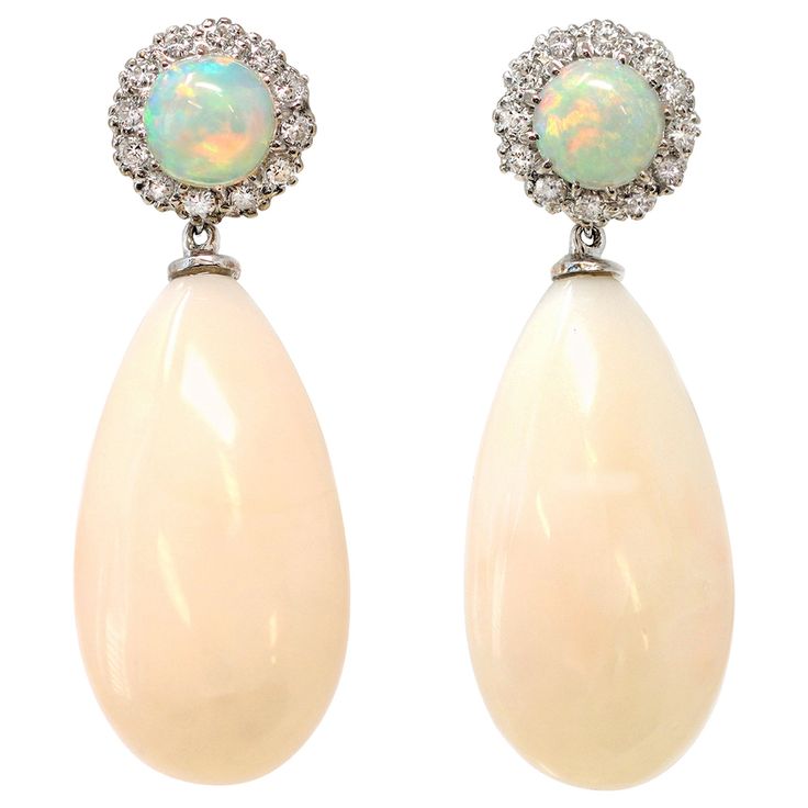 A one-of-a-kind dangling earrings featuring light pink coral drops dangling from a round opal stud surrounded by a halo of diamonds. The earrings are set in 18-karat white gold; they are vintage, circa 1960-70. The hallmarks read S&R. The diamond's estimated weight is 0.48 carats GH color and VS-SI clarity. They measure 1.48” long and 0.53” wide. The gross weight is 12.6 grams. They have posts and pushbacks. Formal Opal Jewelry With Gemstone Accents, Opal Jewelry With Gemstone Accents For Formal Occasions, Elegant Multi-stone Opal Jewelry, Elegant Opal Jewelry With Gemstone Accents, Elegant Pink Opal Jewelry For Formal Occasions, Elegant White Pink Opal Jewelry, Elegant Formal Pink Opal Jewelry, Elegant Opal Jewelry For Formal Occasions, Elegant Opal Jewelry For Formal Events