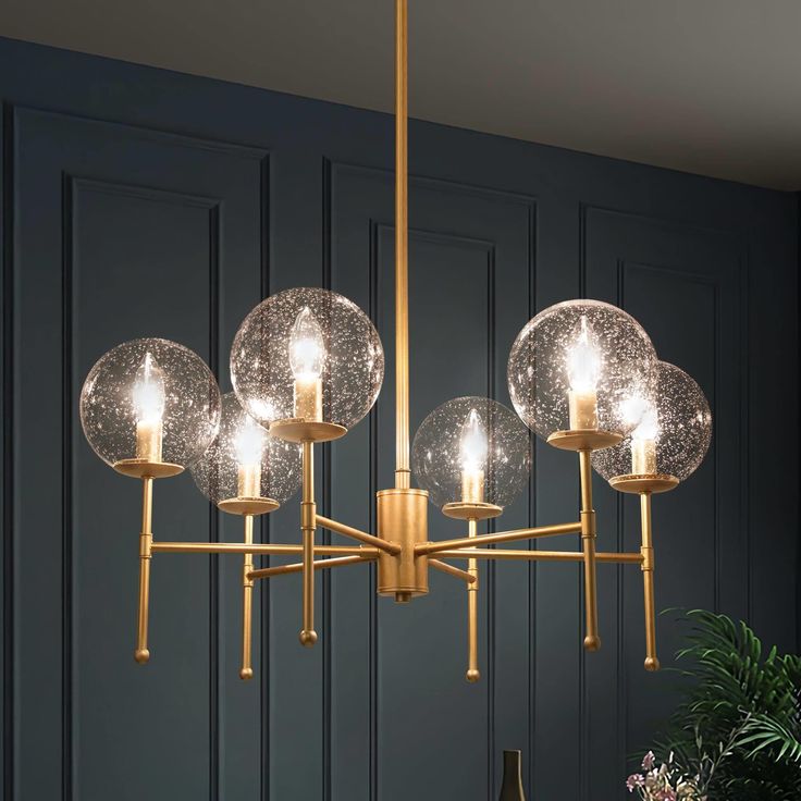 The 6-Light Modern Gold Chandelier by Uolfin Lighting is a modern design that combines classic elements. This Sputnik glass chandelier light displays modern beauty with its chic appeal. The dining room chandelier takes a pretty brass gold color finish, the candlestick lamp holder design offers a more traditional look, while the Sputnik element stands for popular trend. An enchanting essence will fill your space from your kitchen island to your living room; this rustic globe chandelier offers a p Gold Chandeliers Dining Room, Modern Gold Chandelier, Circle Chandelier, Dining Room Light Fixture, Gold Dining, Classic Chandelier, Dining Room Light Fixtures, Globe Chandelier, Contemporary Chandelier