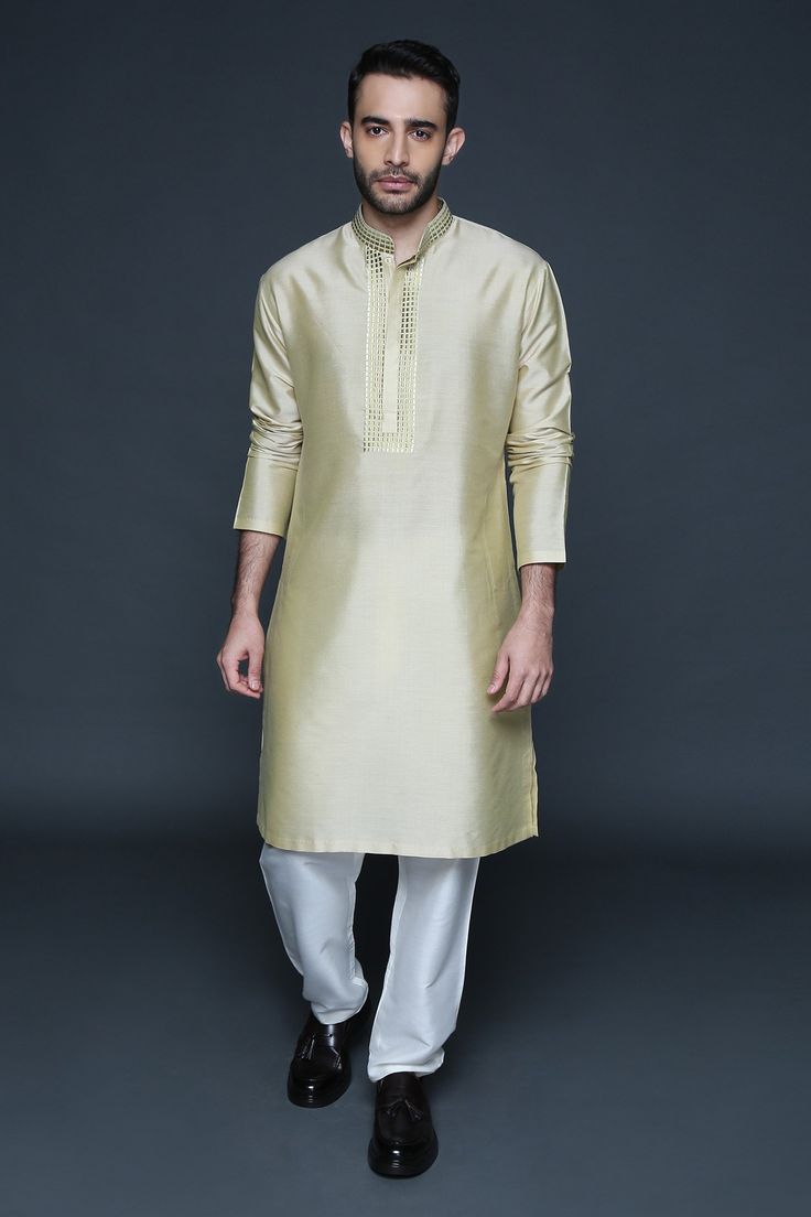 Gold beige cotton silk kurta with mandarin collar, full sleeves and geometric pattern resham thread embroidered placket. Paired with pants.
Component: 2
Pattern: Embroidered
Type Of Work: Resham Thread Work
Neckline: Mandarin Collar
Sleeve Type: Full Sleeves
Fabric: Cotton Silk
Color: Gold,Beige
Other Details: 
Front concealed placket
Side slits on kurta
Occasion: Mehendi and Puja,Sangeet - Aza Fashions Kurta Set For Men, Silk Kurta, Thread Work, Kurta Set, Full Sleeves, Embroidered Silk, Mandarin Collar, Cotton Silk, Aza Fashion