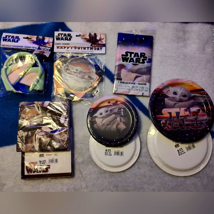 various star wars items are displayed on a table with plastic wrappers and other items