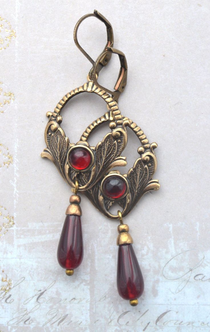 VINTAGE ELEMENTS Unique Jewellery, Handmade from Vintage Inspired Original Designs Art Nouveau style antiqued gold brass Floral Earrings with Red Glass drops  and corresponding Glass Cabochon detail. These earrings have antiqued brass leverback earwires and measure 6.cm from the top of the earwires. Art Nouveau Fashion Modern, Antique Jewelry Silver, Red And Gold Earrings, Whimsigoth Earrings, Gold Antique Jewellery, Italian Earrings, Art Nouveau Fashion, Antique Brass Jewelry, Antique Gold Earrings