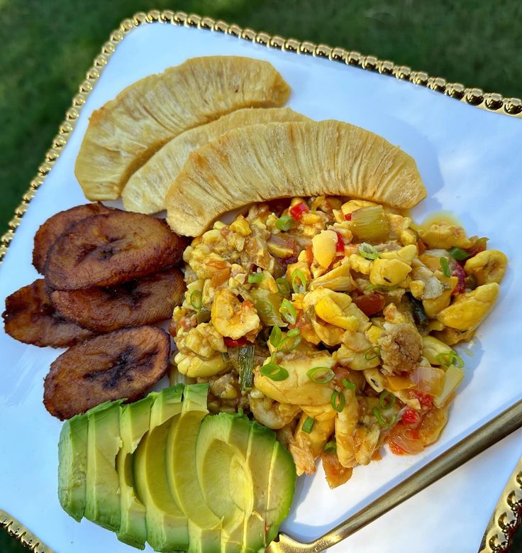 a white plate topped with sliced up bananas and other food on top of a table