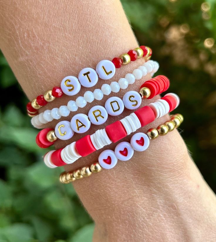 This is a cute stack of 5 bracelets, perfect for any Saint Louis Cardinal Fan!  ❤️The wording can be changed~ example: birds, a player's name, etc.  ❤️This stack can be made in gold or silver.  ❤️All gold beads are 14k gold filled, anti-tarnish beads.  ❤️{Personalization} Please let me know if you would like any wording changed, and if you would like the bracelets made with gold or silver beads. ❤️{Sizing}  These come in any size~ adult or kids. To find your perfect size, please see the measurement instructions in the item images. The average adult size is 7.  Please feel free to message me with any questions. Thank you! Softball Beaded Bracelet, Personalized Red Friendship Bracelets, Red Personalized Friendship Bracelets, Personalized Red Friendship Bracelets For Everyday, Everyday Personalized Red Friendship Bracelets, Trendy Personalized Red Friendship Bracelets, Adjustable Red Bracelet With Letter Beads, Personalized Red Stretch Bracelet, Casual Style, Adjustable Personalized Red Stretch Bracelet