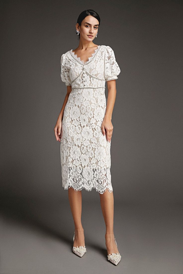 This lace crochet V-neckline midi dress will fill any of your little white dress needs, from your bridal shower to your after party. The textured lace overlay, accented with thick embroidery that outlines the lace’s blooms. Also features puff sleeves and delicate scalloped eyelash lace hem. The rhinestone trim and buttons adds an extra glitz and glam. No Stretch Medium Weight Size runs small,recommend one size up Fabric: 100% Polyester,Lining: 100% Polyester Model is 174cm/5'7" tall, 81cm/32" bust, 61cm/24" waist and 90cm/35" hip and wears a size S. Care Instruction: Hand Wash, Do not bleach, Dry flat in shade, Iron cool (max 110â„?, Dry clean, tetrachloroethylene(PCE) only.Please note: The images represent actual product though color of the image and product may slightly differ. This item Delicate Lace V-neck Dress For Brunch, Evening Lace Dress With Lace Top And Midi Length, Elegant Midi Dress With Delicate Lace For Party, Elegant Knee-length Lace Dress, Elegant Lace Midi-length Mother Of The Bride Dress, Elegant Party Midi Dress With Delicate Lace, Elegant Midi-length Crochet Dress With Scalloped Lace, Lace Top Midi Dress For Evening, Evening Midi Dress With Lace Top