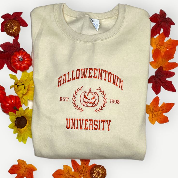 It's that spooky season again! Get your Halloween on with this awesome embroidered crewneck sweatshirt. This embroidered hoodie is available in various sizes and colors. Perfect for the fall, this crewneck sweatshirt is sure to help you celebrate Halloween all season long. Get in the Halloween spirit with this festive sweatshirt perfect for the fall season. It's a great gift for anyone who loves witches, pumpkins, or seasonal decor! This is a one of a kind embroidered sweatshirt that you're gonn Collegiate Crew Sweatshirt For Fall, Fall Collegiate Sweater With Embroidered Logo, Collegiate Fall Sweater With Embroidered Logo, Collegiate Sweatshirt With Embroidered Logo For Fall, Fall College Embroidered Tops, Embroidered Fall Tops For College, Cotton Hoodie For College In Fall, Fall College Sweater, White Hoodie With Embroidered Graphics For Fall