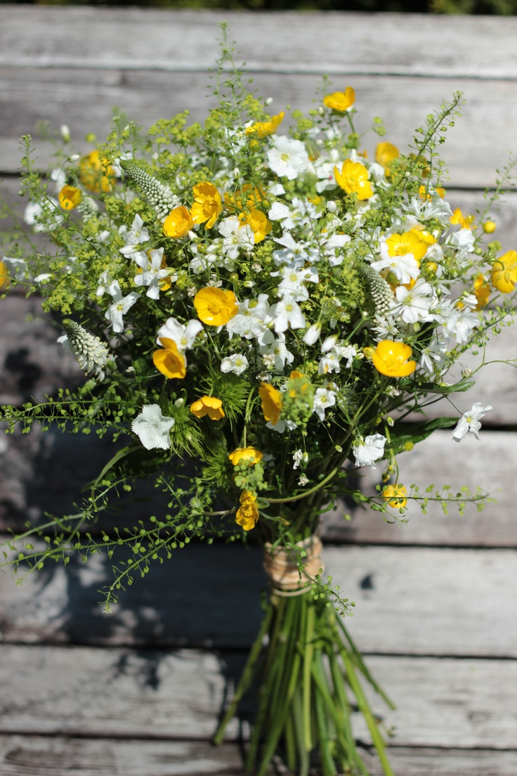 a bouquet of yellow and white flowers in a vase