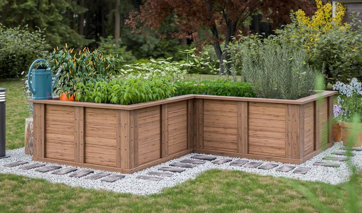 a wooden planter box sitting in the middle of a yard