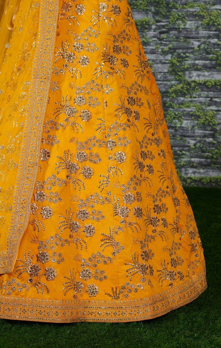 A perfect definition of superb craftsmanship in this beautiful Yellow colored designer sabyasachi bridal lehenga choli.
Beautified with amazing heavy embroidery with zari,dori & sequence work within the attire adds a sign of elegance statement with your look.
The semi-stitched lehenga is made of Thai Silk fabric accompanied with unstitched embroidered matching fabric blouse piece and embroidered Thai Silk dupatta.
Suitable to wear for wedding functions, engagement ceremony and special occasi Semi-stitched Silk Lehenga With Gold Embroidery, Designer Gold Art Silk Lehenga, Gold Art Silk Lehenga With Resham Embroidery, Festival Anarkali Set In Dola Silk With Gold Embroidery, Festival Anarkali Set With Gold Embroidery On Dola Silk, Gold Raw Silk Lehenga For Navratri, Designer Yellow Anarkali Set With Intricate Embroidery, Gold Lehenga In Art Silk For Festivals, Traditional Art Silk Dupatta With Gold Embroidery