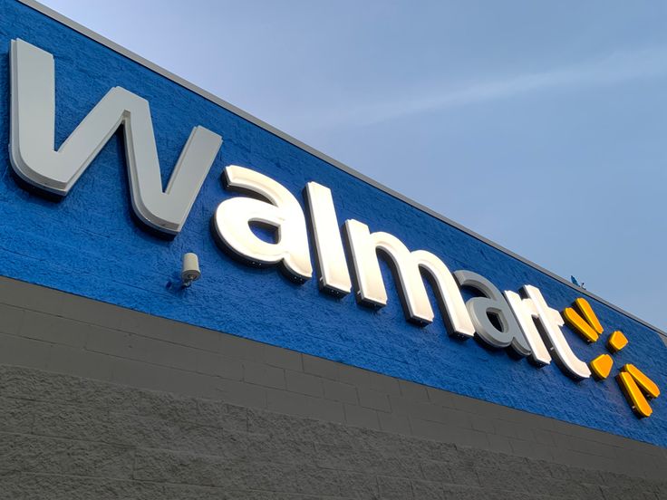 walmart sign on the side of a building with blue sky in the back ground