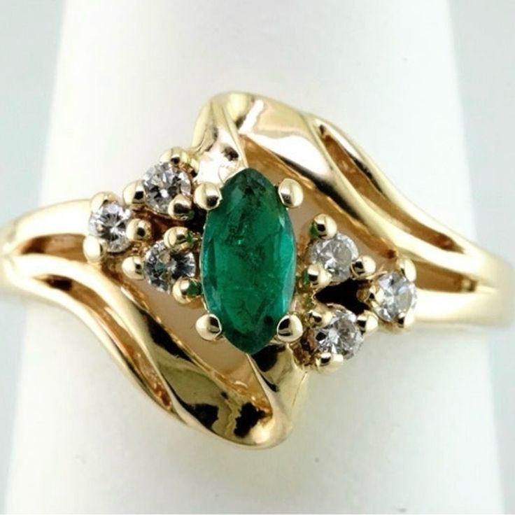 This 14k Yellow Gold Mounting Holds A .20ct Marquise Cut Emerald Along With .10ctw Of Si G/H Accent Diamonds. Size 6 14k Gold Cluster Diamond Ring, 14k Gold Cluster Diamond Ring Fine Jewelry, Stamped 14k Diamond Fine Jewelry, Marquise Emerald Diamond Ring With Brilliant Cut, Fine Jewelry Diamond Emerald Ring Marquise Cut, Fine Jewelry Marquise Cut Diamond Emerald Ring, Cubic Zirconia Ring With 17 Jewels, Marquise Diamond Ring With 17 Jewels, Formal Marquise Emerald Ring With Brilliant Cut