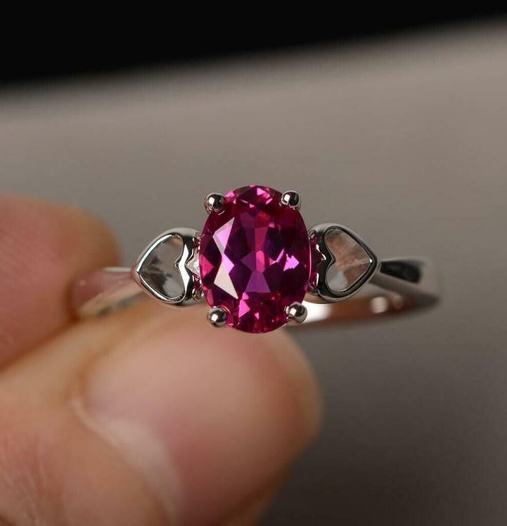 "Show your love with our Pink Oval Cut Simulated CZ Solitaire Promise Ring. Made from high-quality 925 Sterling Silver, this ring features a dazzling pink oval-cut CZ stone that symbolizes your promise to cherish your loved one forever. It's the perfect choice for an engagement, anniversary or simply a special way to say 'I love you'." #pinkczring #solitairering #925sterlingsilver #promisering #herpromisering #affordablejewelry #loversring #ovalcutring #weddingjewelry #anniversarygift Oval Ruby Ring With Vvs Clarity Diamond, Oval Ruby Ring With Diamond, Oval Cubic Zirconia Promise Ring, Oval Ruby Ring With Brilliant Cut For Gift, Oval Ruby Ring With Prong Setting For Promise, Oval Ruby Ring With Brilliant Cut As Gift, White Gold Ruby Ring With Accent Stones, Oval Shaped, Oval Ruby Ring For Promise, Oval Cubic Zirconia Fine Jewelry Rings