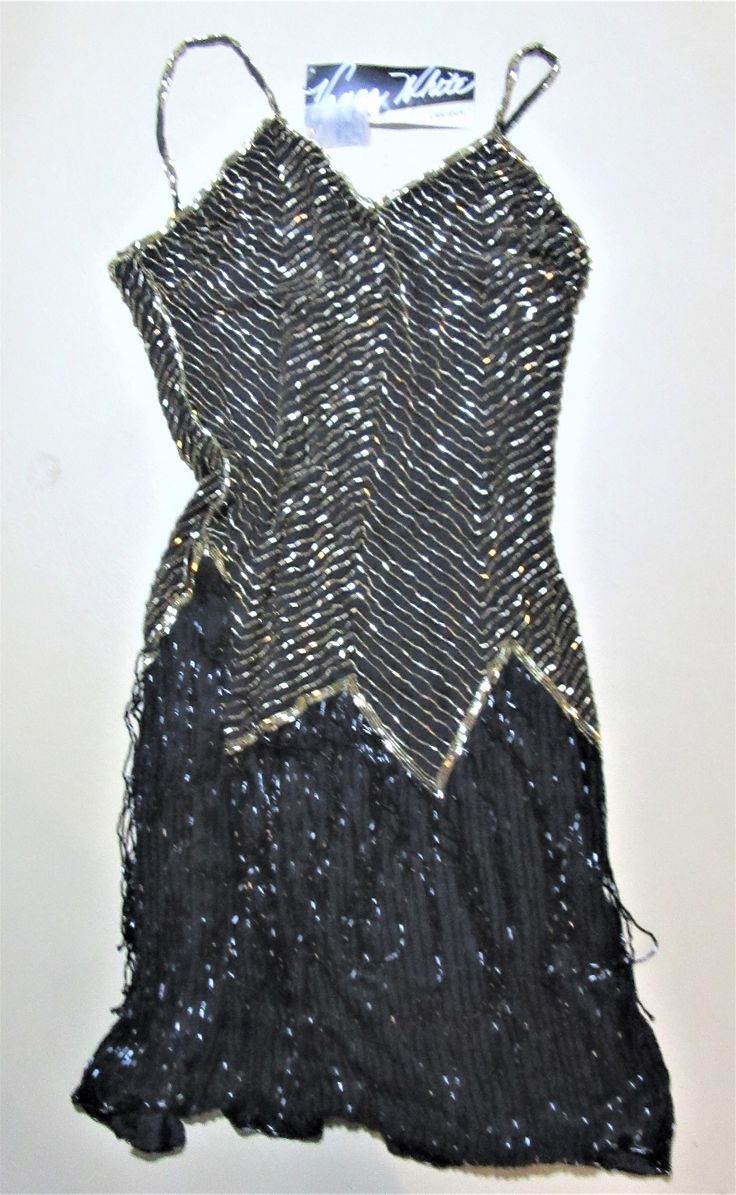 Vintage Vanna white Beaded Black / gold gown small Clingy Unused ...with tage chest 32 hips 34 / 36 moving black fringe on shirt Flapper Sequin Evening Dress For Party Season, Fitted Flapper Style Sequin Evening Dress, Fitted Flapper Dress With Beaded Fringe For Costume Party, Embellished Fitted Flapper Dress For Costume Party, Fitted Beaded Fringe Flapper Dress For Costume Party, Beaded Flapper Party Dress, Flapper Party Dress With Beaded Details, Embellished Flapper Dress For Costume Party, Holiday Sequin Flapper Dress For Costume Party