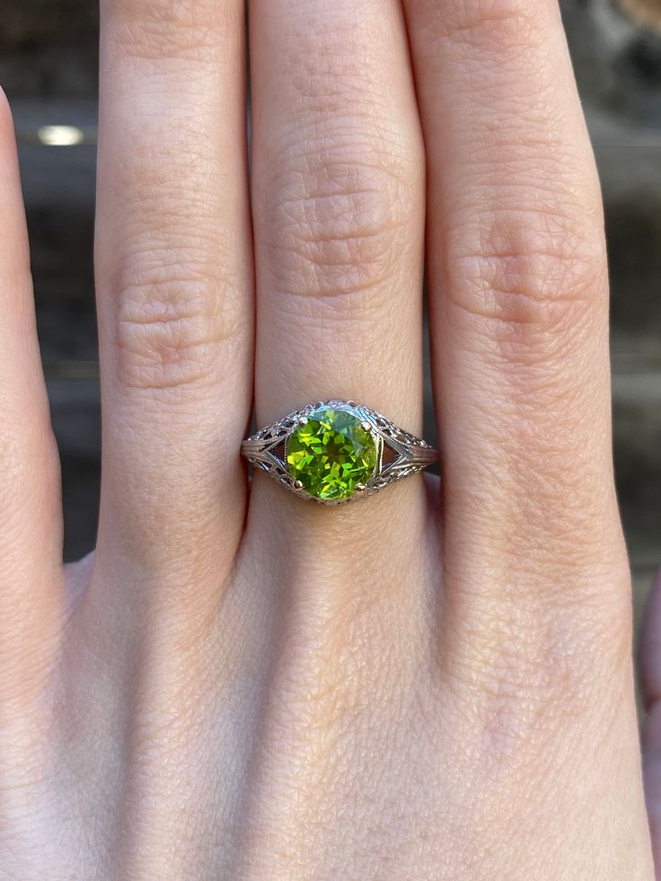 Total Weight: 3.4 grams Size: 6.25 Band Width: 1.2-10.2mm Peridot: 7mm Condition: In great condition showing little wear with no damage. All gold has been thoroughly checked with an Olympus XRF spectrometer. It is guaranteed 18k gold.  All our jewelry is properly washed and disinfected to ensure customers get clean items with every order.  Returns accepted but may be subjected to a restock fee.  Please message with any questions:) Green Gemstone Diamond Ring With Round Band, Peridot Ring With Prong Setting In Round Cut, Green Peridot Birthstone Ring For Formal Occasions, Green Peridot Birthstone Ring For Formal Events, Platinum Green Diamond Ring, Formal Peridot Birthstone Ring For May, Classic Peridot Gemstone Diamond Ring, Classic Peridot Diamond Ring, Oval Peridot Diamond Ring For Formal Occasions