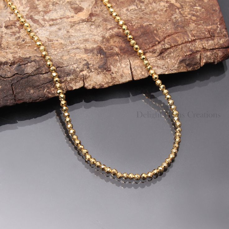 PRODUCT DETAIL : ITEM : GOLDEN PYRITE BEADED NECKLACE ITEM CODE : DGC4269 ITEM NAME :NECKLACE GEMSTONE : GOLDEN PYRITE BEADS SHAPE : MICRO FACETED ROUND LENGTH : 18 INCH APPROX BEADS SIZE: 3 MM Approx WEIGHT : 55 Cts. APPROX CUSTOMIZATION/BULK ORDER : AVAILABLE PLEASE FEEL FREE TO CONTACT IF YOU REQUIRE ANY FURTHER INFORMATION. Gold Chain Necklace With Round Beaded Details, Gold Rondelle Beaded Necklaces For Spiritual Style, Gold Single Strand Round Bead Necklaces, Gold Spiritual Beaded Necklace With Faceted Beads, Gold Single Strand Round Bead Necklace, Gold Round Beaded Necklaces, Spiritual Gold Beaded Necklace With Faceted Beads, Minimalist Gold Round Bead Jewelry, Minimalist Gold Round Beads Jewelry