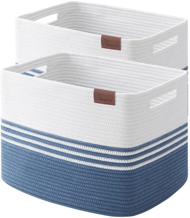 two blue and white storage baskets with brown labels on the handles, one is empty