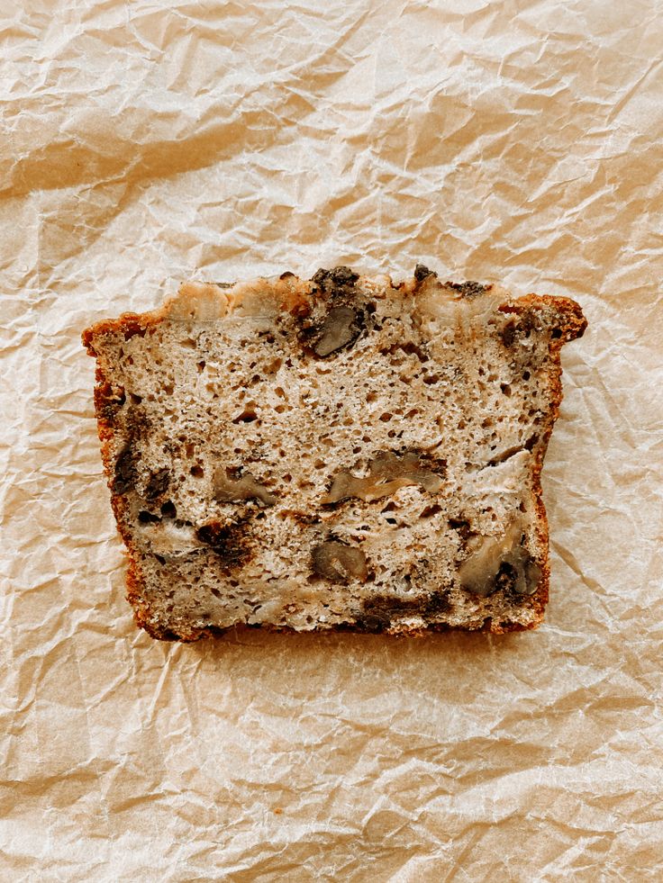 a piece of bread that is sitting on some paper