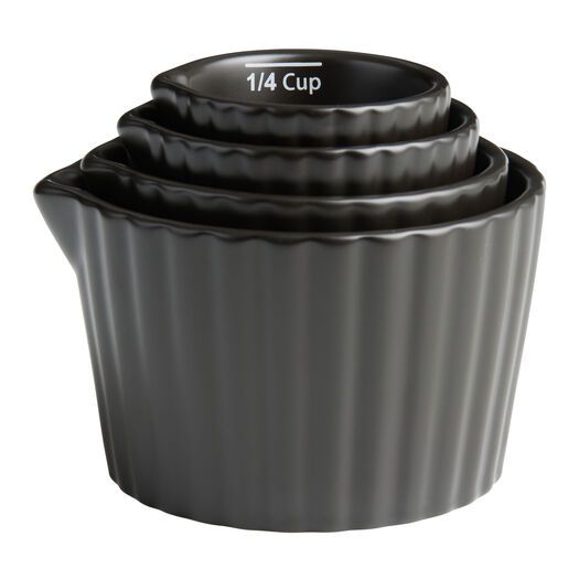 three black cupcake pans stacked on top of each other