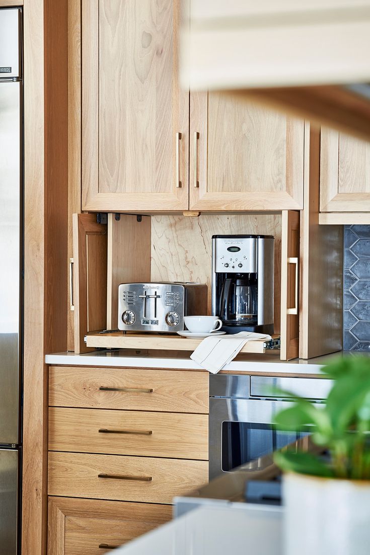 a kitchen with wooden cabinets and stainless steel appliances, including a coffee maker on the counter