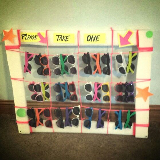 there is a display with pairs of shoes on it that says please, take one