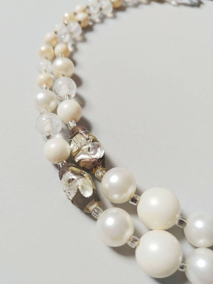 1950s two strand beaded necklace  ~Cream, clear, faux pearl, and art glass beads ~Back adjustable length hook closure Length: 14.25-15.75" Condition: Very good. Some corrosion to metal Message us with any questions! Sarah Vogt Vintage Single Strand Jewelry For Wedding, Vintage Single Strand Wedding Jewelry, Elegant Multi-strand Glass Beaded Necklaces, Vintage Single Strand Wedding Necklace, Elegant Clear Single Strand Beaded Necklace, Elegant Single Strand Clear Beaded Necklace, Vintage Pearl White Beaded Necklace With Pearl Chain, Vintage Adjustable Pearl White Jewelry, Vintage Pearl White Jewelry For Party