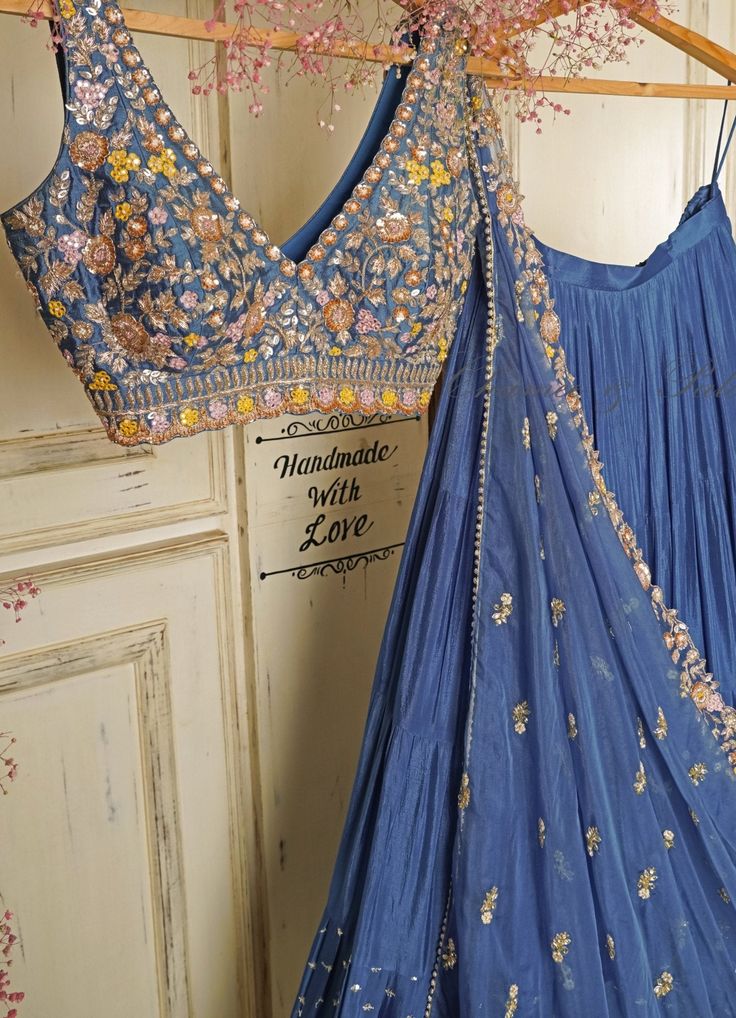 Summer Vibes ! Features a blue ruffled lehenga in soft georgette teamed with a zardosi and resham embroidered raw silk blouse in summer colours. Completed with a pre draped tulle dupatta with an embroidered border Composition : Lehenga- Georgette, Blouse-Silk, Dupatta-Tulle Care: Dry Clean Only and Vacuum Storage This product can be customised for sleeves, length of blouse and neckline Delivery : 6-8 weeks as the product is hand crafted. For more information and sizes please contact fabiliciousfashion@gmail.com or visit our Copenhagen studio.About the Designer : Born and brought up in the bustling city of Mumbai, Chamee and Palak come from a family of successful entrepreneurs and a deep-rooted love for textiles. Their childhood was filled with lively discussions and inspiring tales around Simple Lehenga, Trendy Outfits Indian, Indian Outfits Lehenga, Floral Lehenga, Wedding Lehenga Designs, Perhiasan India, Lehenga Designs Simple, Traditional Indian Dress, Half Saree Designs