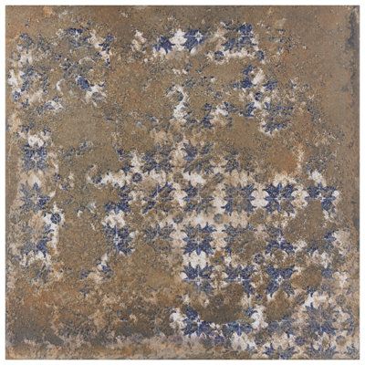 an old tile with blue and white flowers on the bottom, in brown grounding