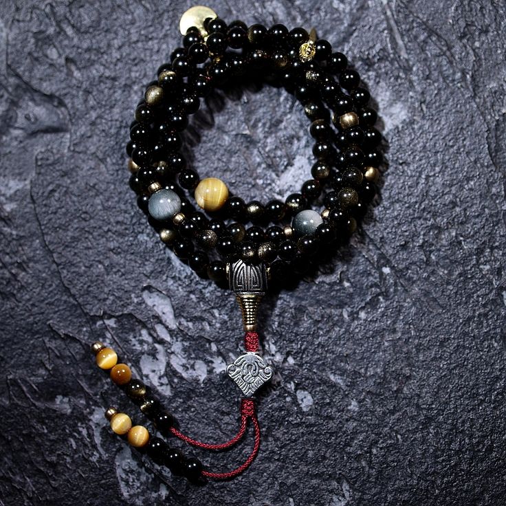 Type: 108 Mala BeadsMaterial: Golden Obsidian Beads Size: 8mm Tibetan Zodiac Sign: BrassCloud Sign: Silver Process: Handmade (up to three days)Package: Eco envelop Golden obsidian has an extremely potent ability to absorb. It is frequently employed for spiritual connection, and protection. Because of its capacity to absorb psychic fog and helps in gaining a clearer perspective, it is sometimes referred to as a spiritual cleanser. What causes the gold sheen in obsidian? Very small inclusions of w Gold Sheen Obsidian, Golden Obsidian, Evil World, Mala Bead Necklace, Sheen Obsidian, 108 Mala Beads, Eagle Eye, Zodiac Pendant, The Buddha