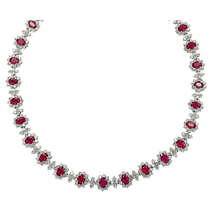 Sensational Diamond and Ruby necklace finely crafted in platinum, featuring Red Burma Rubies and white diamonds weighing approximately 47.25 carats total. This exceptional necklace showcases 406 round brilliant cut diamonds weighing 21.79 carats total, H-I color, VS2-SI1 clarity, 29 Oval Burma Rubies weighing 25.46 carats total. The white diamonds are placed beautifully around the red Burma Rubies capturing the unparalleled beauty of nature. The infinite attention to detail continues to the hidden box clasp, which is adorned with a oval Burma Ruby and white round brilliant cut diamonds. This gorgeous necklace measures 16.25 inches in length, 10.6 mm in width, and weighs 59.1 grams. Our pieces are all accompanied by an appraisal performed by one of our in-house GIA Graduates. They are also Diamond White Ruby Necklace With Diamond Accents, Fine Jewelry Ruby Necklace In Diamond White, Luxury Ruby Necklaces With Diamond Accents, Luxury White Ruby Necklace, Luxury Ruby Necklace With Brilliant Cut, Ruby Diamond Necklace, Ruby Jewelry Necklaces, Ruby And Diamond Necklace, Ruby Necklace