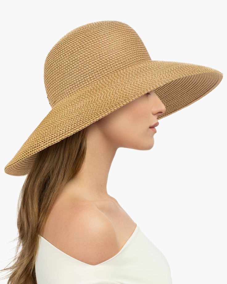 Made from partially recycled materials, our patented Squishee® straw has a classic look you will love. This sustainable product of man-made materials looks and feels like authentic raffia straw and is more durable than a hat made of natural fiber. If you have been searching for a woman's designer packable hat for sale, this is a style you will use for many years to come. Bella rolls and folds into a tote bag for travel and will emerge wrinkle-free when unpacked. Eric Javits' Squishee® hats are k Lightweight Solid Straw Hat, Classic Woven Straw Sun Hat, Eco-friendly Lightweight Straw Hat For Vacation, Eco-friendly Lightweight Straw Hat For Spring, Natural Packable Straw Hat For Summer, Packable Natural Straw Hat, Brimmed Straw Hat, Palm Leaf Sun Hat For Travel, Everyday Natural Toquilla Straw Hat