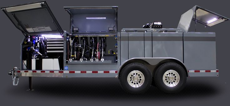 the back end of a silver truck with its doors open and tools in it's compartment