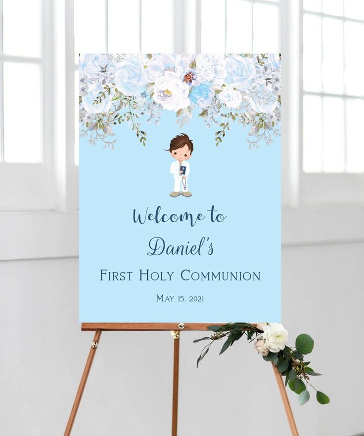 a welcome sign with flowers and a boy on it