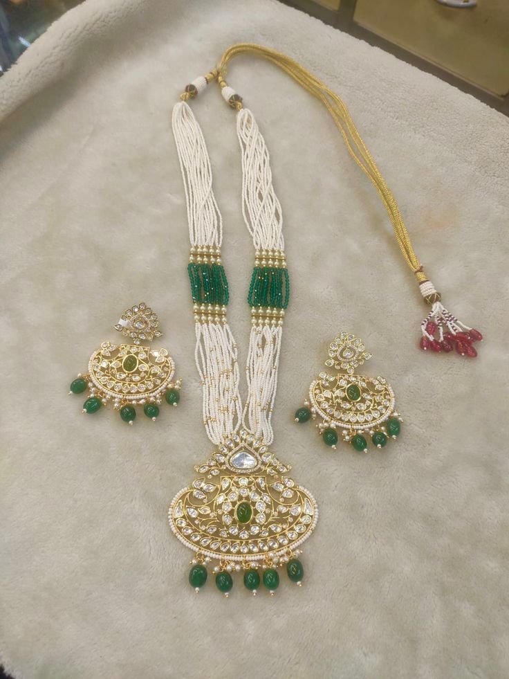 All our pieces are in stock and will be dispatched within 24 to 48 hours of order. Orders received during the weekend will be dispatched on Monday The white and green beads strings on both sides of an elegant Kundan pendant make it a statement wedding necklace. One of our favorite picks for the wedding season 2022❤️ The drop length of the necklace: is approximately 11 inches, and comes with an adjustable string. Length of Earrings: 2 inches White Kundan Necklace With Matching Earrings In Temple Style, Traditional White Kundan Necklace With Matching Earrings, Traditional White Kundan Necklace With Earrings, White Jewelry With Stone Work For Gift, White Temple Jewelry Set With Matching Earrings, Ceremonial White Stone Work Necklace, White Hand Set Temple Jewelry, White Temple Jewelry Sets For Ceremonial Use, White Temple Jewelry Sets For Ceremonial Occasions