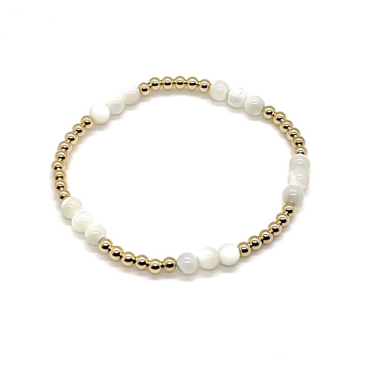 Minimalist Bracelets with Maximum Impact A gorgeous set with mother-of-pearl and 14K gold fill beads in varied sizes for texture and dimension. A perfect gift for you, your maid of honor, bridesmaids, & friends. 14K gold-filled 2mm, 3mm, & 5mm round beads. Mother-of-Pearl 4mm & 6mm round beads. Stretch style. Waterproof and non-tarnishing. Gorgeous individually or as a trio! Handmade in NYC. Pairs beautifully with: Crystal Bracelet Trio 3mm & 4mm gold ball bracelets Dainty White Stretch Bracelet With Gold Beads, Minimalist White Bracelet With Gold Beads, Everyday White Hand-strung Pearl Bracelet, Classic White Pearl Bracelet With Gold Beads, Hypoallergenic White Pearl Bracelet In 14k Gold Filled, Minimalist White 14k Gold Filled Beaded Bracelets, Everyday White 14k Gold Filled Bracelets, Everyday White Pearl Stretch Bracelet, Adjustable White Pearl Bracelet In 14k Gold Filled