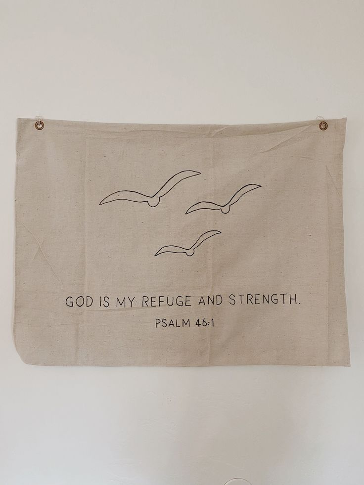 a banner hanging on the wall that says god is my refuge and strength with two seagulls