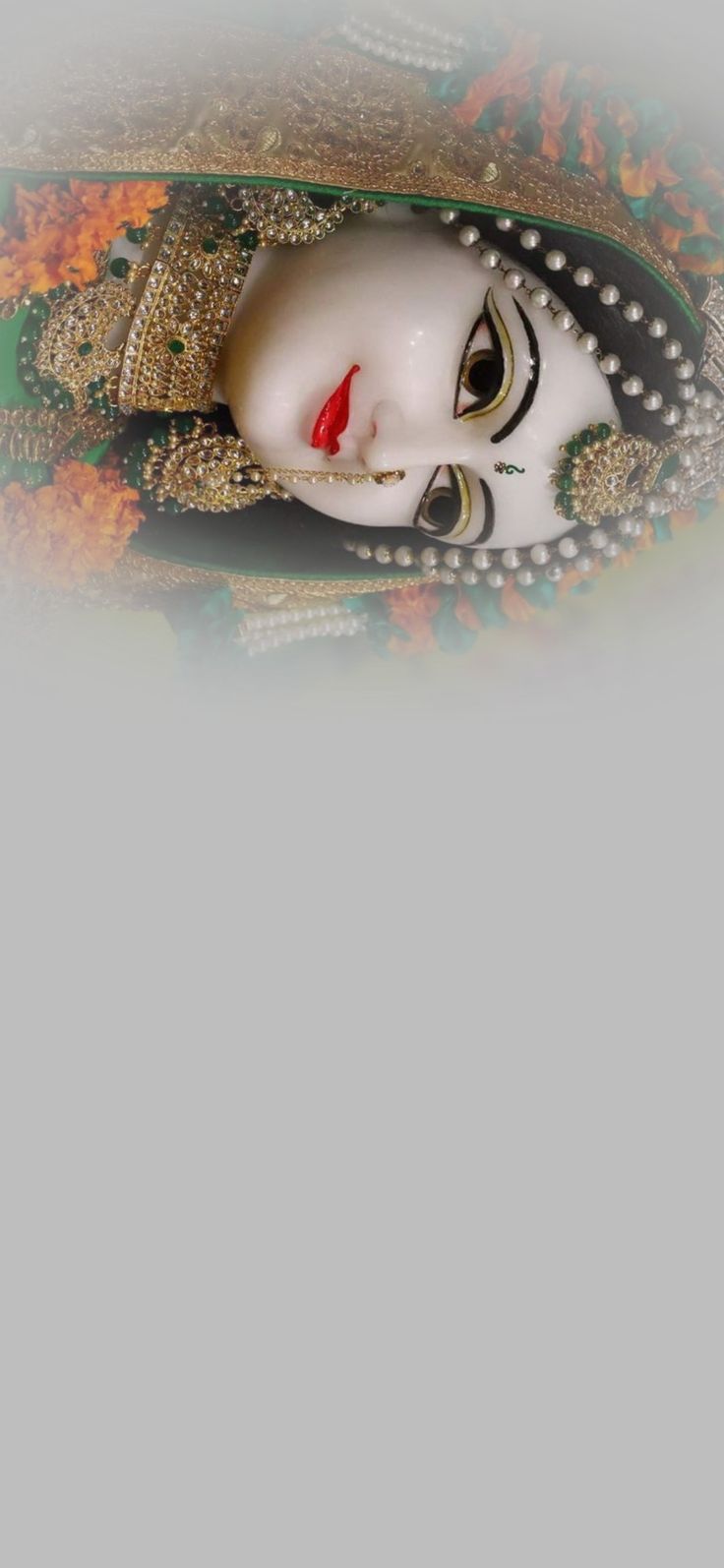 a white mask with red lips and pearls on it