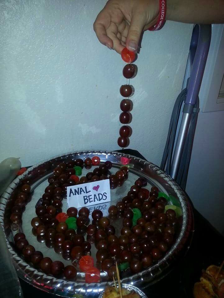 a person is placing candy on top of a cake plate with an animal bead