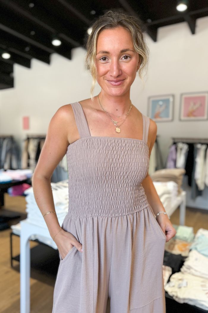 The Sleeveless Smock Wide Leg Jumpsuit gives you an oversized look that flatters your figure, while the smocked top ensures a comfy fit. With its flowy design, the bottom has a loose, long fit, but might need some hemming or to be worn with heels for shorter inseams. Or, you can rock a longer hemline for a chic and on-trend style. Model is 5'10" and wearing a size Small.