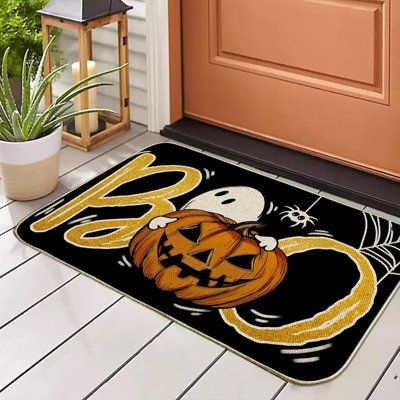 a door mat with a pumpkin and ghost on it