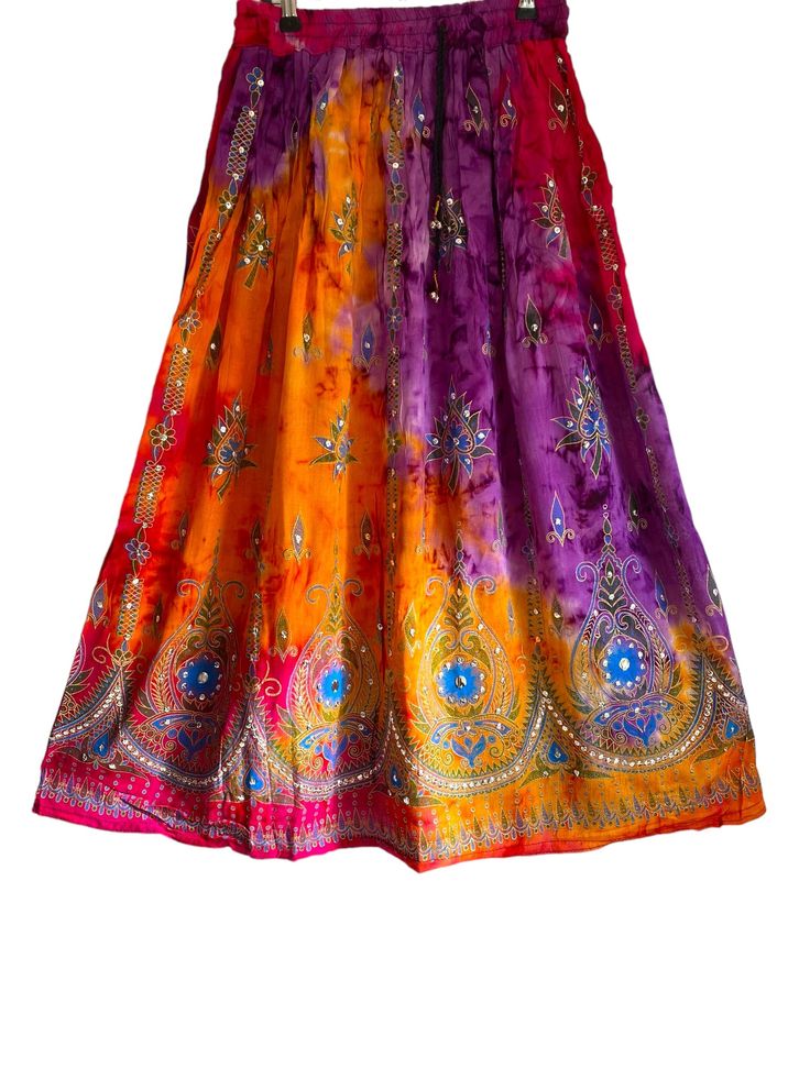 Peony Long Tye Dye Skirt One size UK 8-14 Wonderfully chic Boho long tye dye Pink and Orange long length gathered skirt. With fully elasticated waist for a great fit, ties to the front with pull cords that have delicate little silver bells at the ends, that jingle with movement. This skirt is adorned with sequins that catch the light as you walk. The ultimate boho look! Made in India especially for Festival Stall.  Material 100% Raylon Measurements:  Length : 36 in  The elasticated waist comfort Bohemian Maxi Skirt For Summer Festivals, Bohemian Maxi Skirt For Festive Occasions, Multicolor Long Maxi Skirt For Festivals, Multicolor Bohemian Maxi Skirt For Festivals, Bohemian Multicolor Maxi Skirt For Festivals, Multicolor Festival Skirt For Navratri, Multicolor Navratri Festival Skirt, Bohemian Multicolor Skirt For Festivals, Traditional Multicolor Maxi Skirt