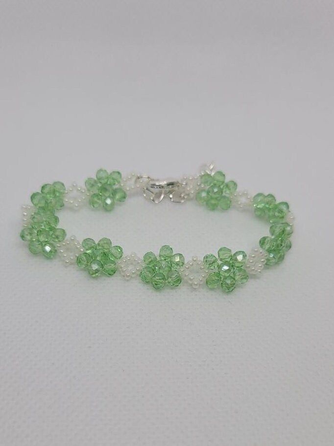 Delicate light green czech crystal bracelet... delicate but durable. This bracelet is so light and easy to wear, you'll forget you have it on.  Suitable for any occasion whether it's everyday wear, or a night out.  4mm green czech rondels 11/0 glass seed beds Lobster clasp Extension chain Adjustable Faceted Bead Bracelets For May Birthstone, Faceted Round Bead Bracelets For May Birthstone, Faceted Round Beads Bracelet For May Birthstone, Elegant May Birthstone Beaded Bracelets With Faceted Beads, Elegant May Birthstone Faceted Beaded Bracelets, Elegant Adjustable Light Green Jewelry, Elegant Green Crystal Bracelets, Hand-strung Beaded Bracelets With May Birthstone, Hand-strung Beaded Bracelets For May Birthstone