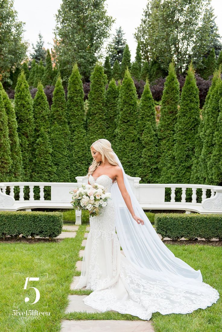 a woman in a wedding dress holding a bouquet