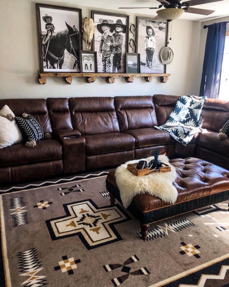 a living room with brown leather furniture and pictures on the wall above it's couch