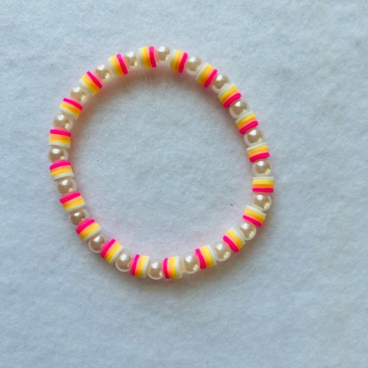 Never Worn/No Damage! Stackable Clay Bead Stretch Bracelet! *This Contains 1 Bracelet Size Is About 7” Can Fit Adults With A Larger Sized Wrists. Contains 4 Different Colors... White, Yellow, Orange And Pink 6mm Clay Beads. Also Has A Cute Peral Spacers All Around The Bracelet!!! This Would Be Such A Cute Gift For Yourself Or Anyone!! The Camera Will Make The Bracelets Seem Brighter Or Darker In The Photos. So Your Bracelets May Be A Little Lighter Or Darker In Person. I Assure You All My Bracel