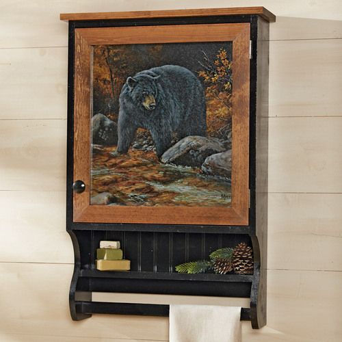 a bear painting hanging on the wall next to a towel rack