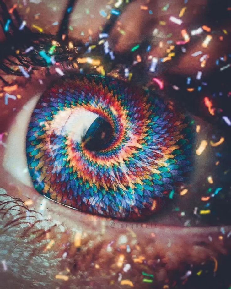 an eye with multicolored confetti on it's iris and eyeshade