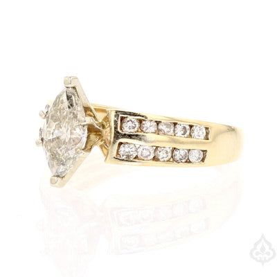 Description: This elegant vintage ring features a marquise shaped diamond as the main stone, set in 14K yellow gold. The diamond has a K color. The ring is also adorned with side diamonds that adds to the overall sparkle of the piece. With a total weight of 4.3g, this ring is perfect for any occasion and it is available in ring size 6.75. Specifications: 14K Yellow Gold (585) Main Stone: Marquise Diamond Main Stone Color: K Side Stones: Diamonds Total weight: 4.3g Ring Size: 6.75 Item Code: 8894 Heirloom Marquise Cluster Ring With Vvs Clarity, Heirloom Cluster Marquise Ring With Vvs Clarity, Classic Marquise Yellow Gold Cluster Ring, Heirloom Marquise Diamond Ring For Wedding, Marquise Diamond Ring With Diamond Accents For Wedding, Marquise Diamond Ring With Accents For Wedding, Heirloom Marquise Diamond Ring In Diamond White, Heirloom Marquise Diamond White Diamond Ring, Fine Jewelry Marquise Diamond Ring With Accent Stones