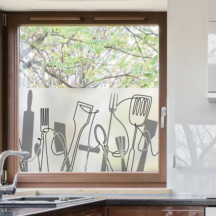 a kitchen window with utensils drawn on it