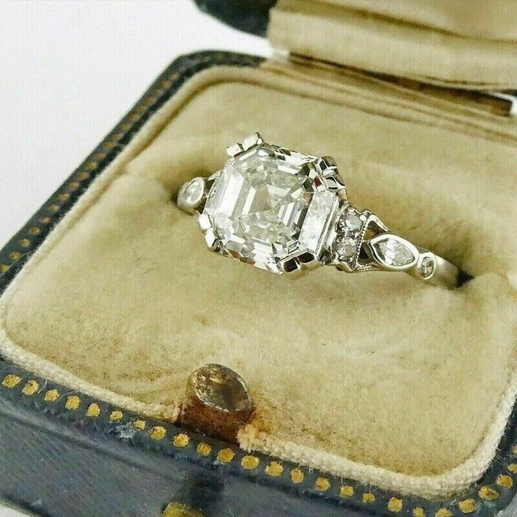 an antique diamond ring sits in its case