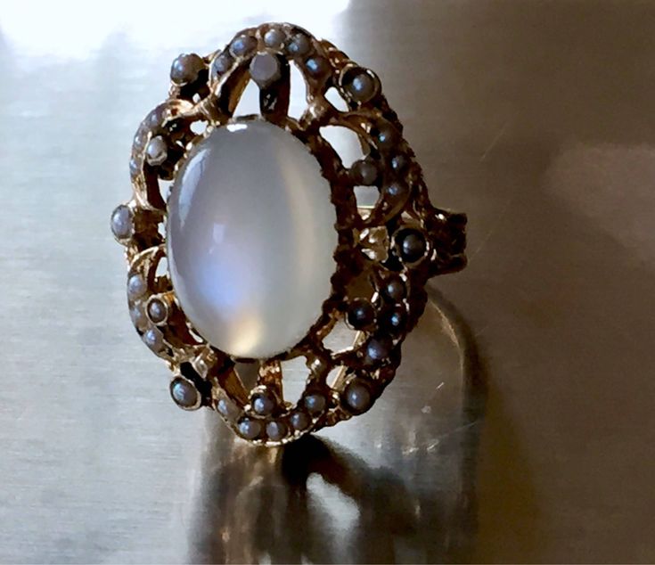 this ring is just incredible!! please see photos! crafted in solid heavy 14k yellow gold and very ornate plus dark enamel and real pearl seeds around!! the rest of enamel is present around the pearls and on the prongs! the pearls are all different in shape and size - because they are natural. all pearl seeds are present, no visible wear to the moonstone! the moonstone is clean and very chatoyant! )with strong chatoyancy effect! - which moves from one side to another as you move your hand!) ! the Antique Oval Moonstone Ring Collectible, Heirloom Oval Moonstone Ring, Antique Oval Hallmarked Moonstone Ring, Antique Oval Moonstone Ring Hallmarked, Vintage Oval Moonstone Ring Hallmarked, Antique Moonstone Oval Cabochon Ring, Antique Oval Cabochon Moonstone Ring, Antique Oval Moonstone Ring, Heirloom Moonstone Ring